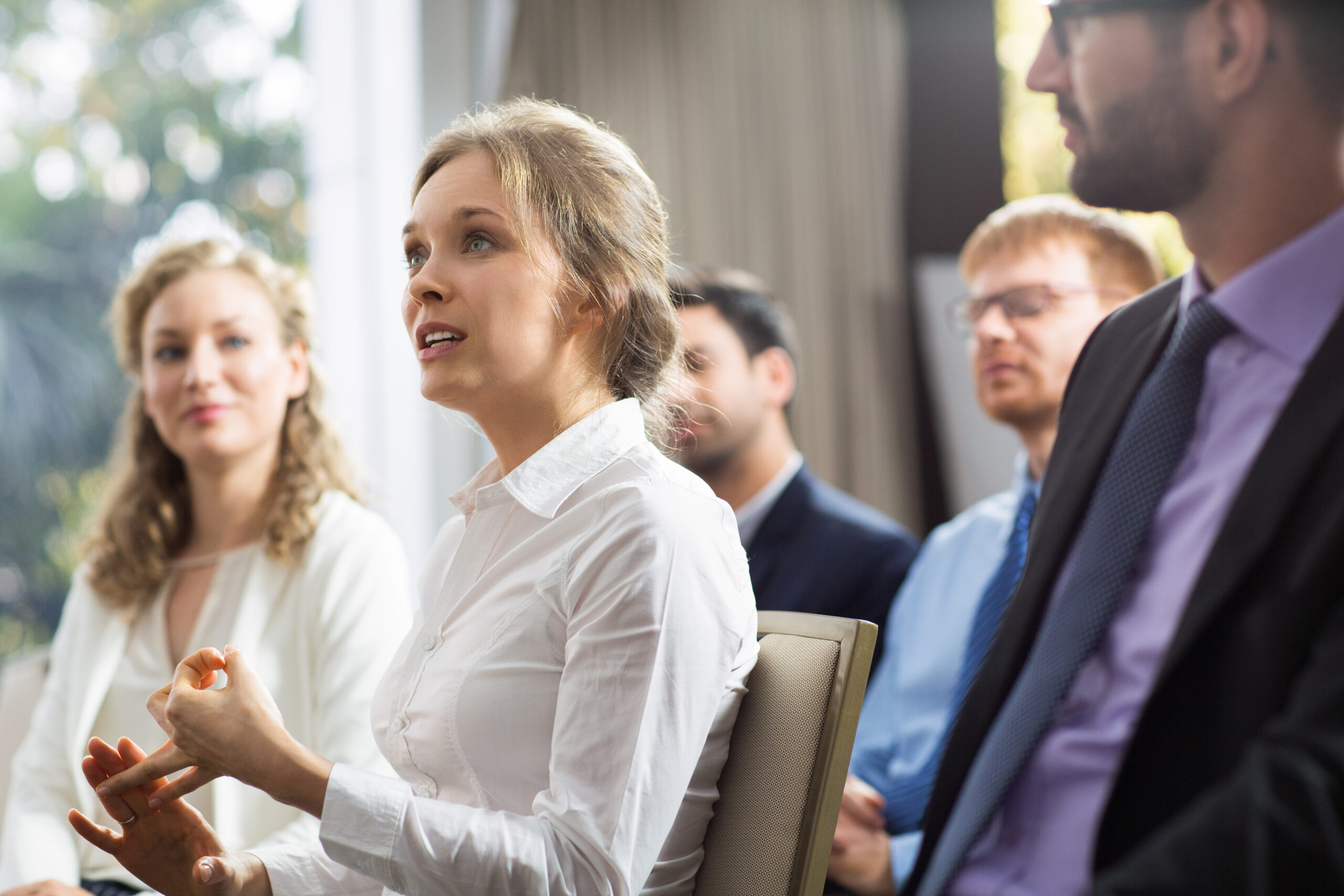 Woman speaking in front of a group